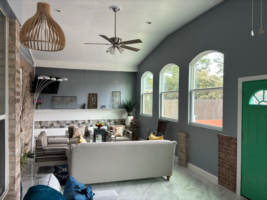Bright & Textured Sunroom: Arched Windows & Brick Accents
